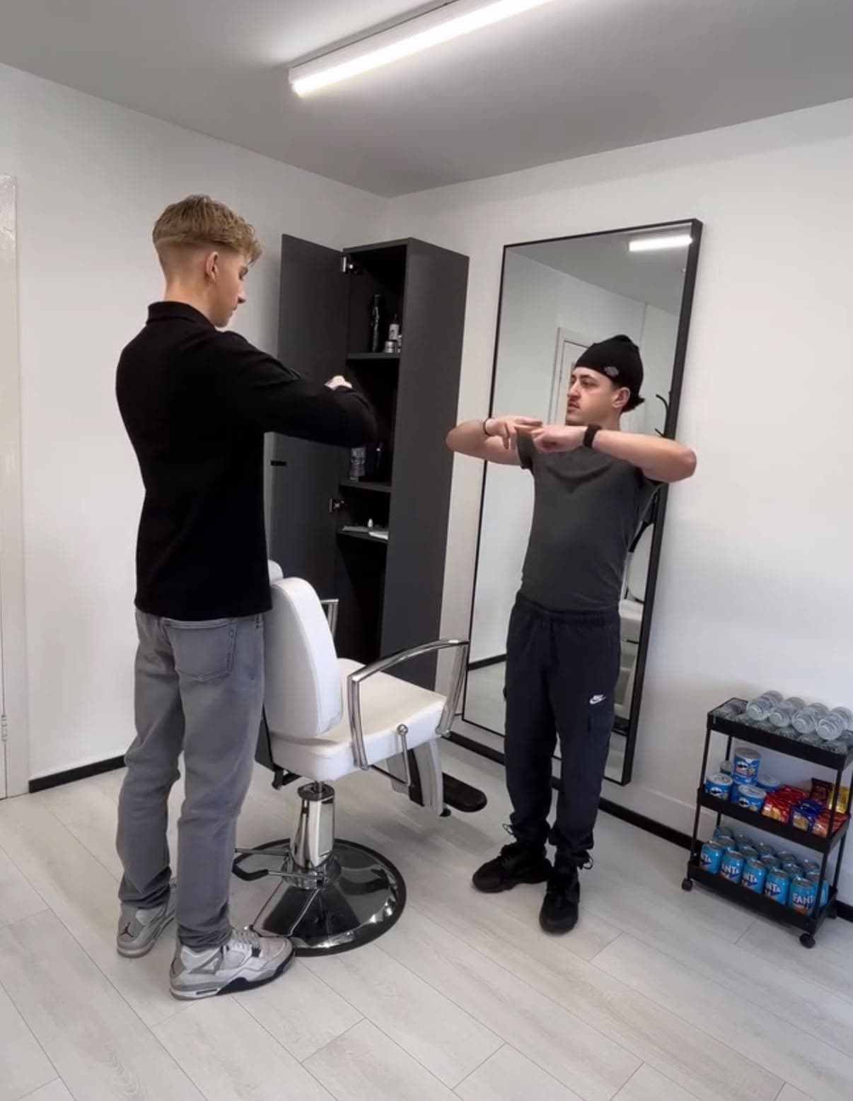 Bucks demonstrating hand position to a trainee beside the chair