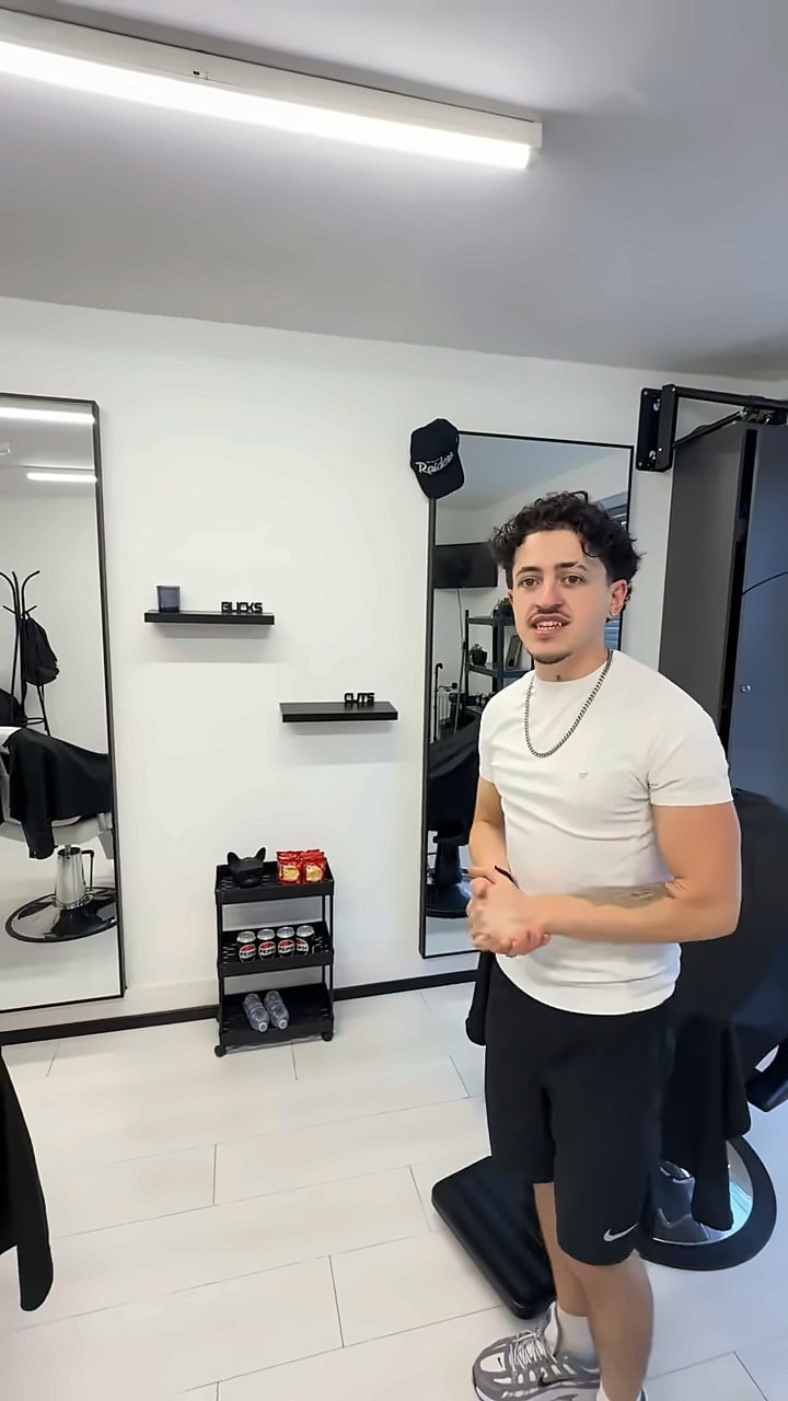 The barber chair in front of the full length mirrors
